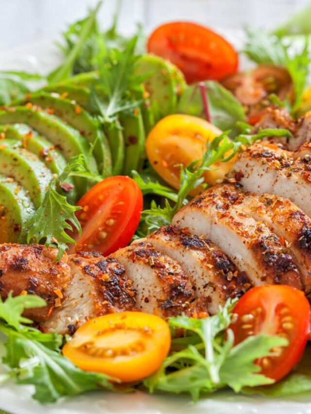 Salad plate with colorful tomatoes, chicken breast and avocado